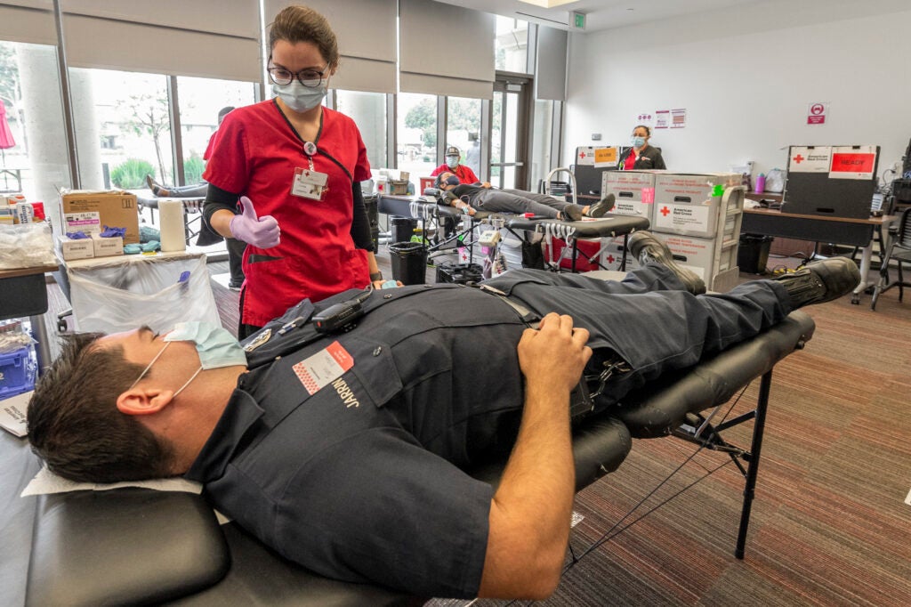 Red Cross technician Camille Costantino checks on USC fire safety specialist Jarrin Black,