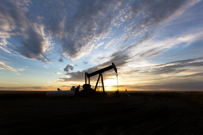 An oil well with the sunset in the backdrop