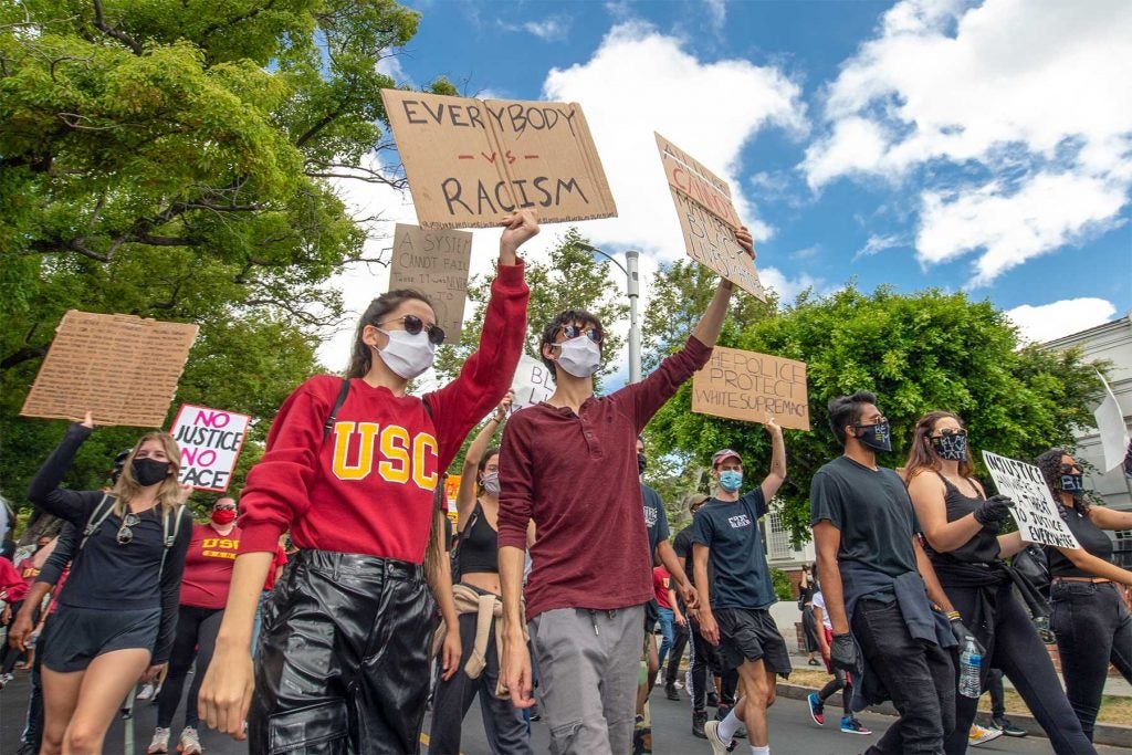 Protesters carry signs in support of the Black Lives Matter movement on June 6, 2020.