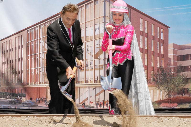 DR. ALLEN AND CHARLOTTE GINSBURG TURN THE SOIL.