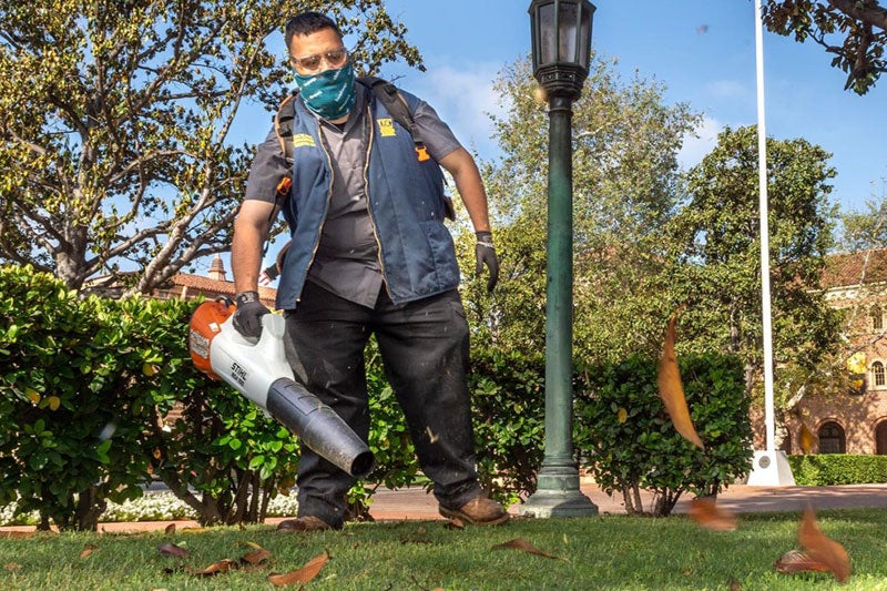 USC groundskeeper blowing leaves on the ground