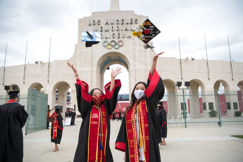 Two USC grads outside the coliseum celebrating