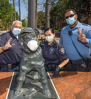 First responders pose in front of Tirebiter's statue