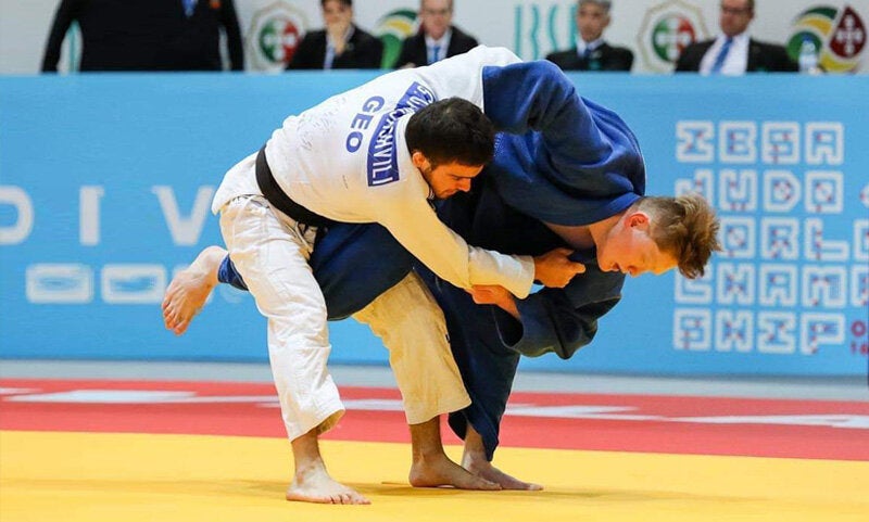 Paralympian Robert Tanaka (right) uses the Uchi-mata throw to attack his opponent during the bronze medal match at the 2018 IBSA World Championships in Lisbon, Portugal.