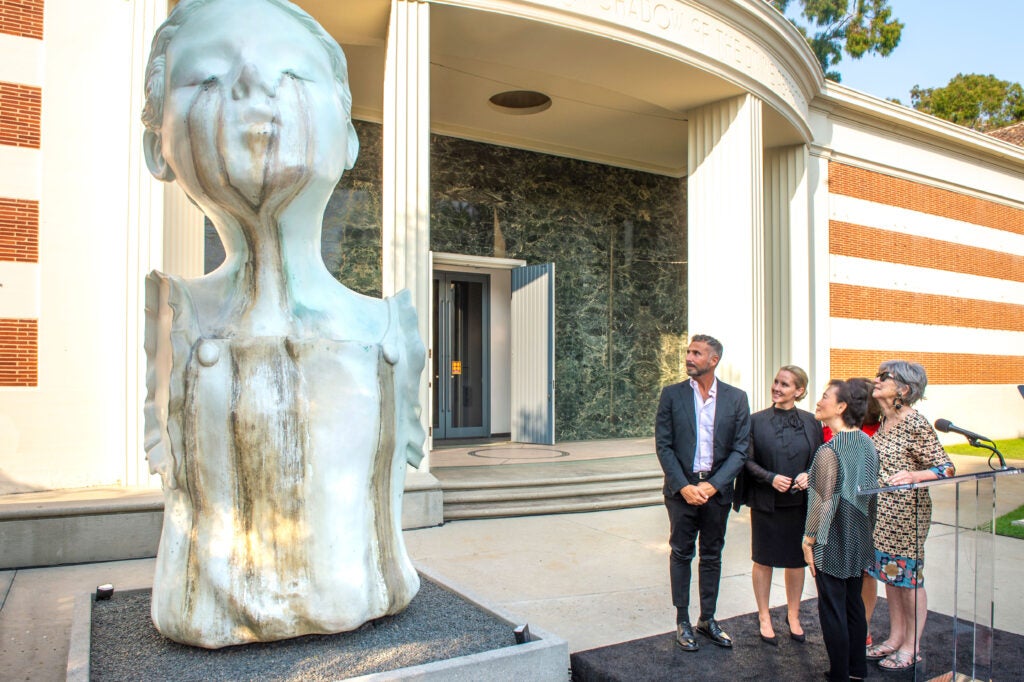 “The Well” was created by artist and USC faculty member Enrique Martínez Celaya, pictured here closest to the sculpture.