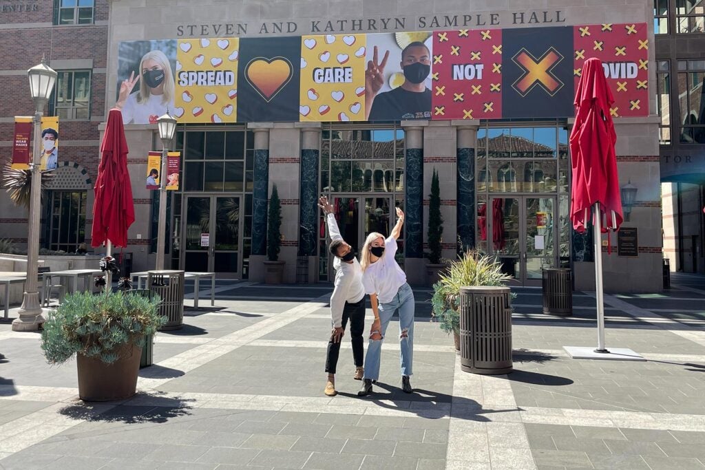 USC students in masks pose by Tutor Campus Center