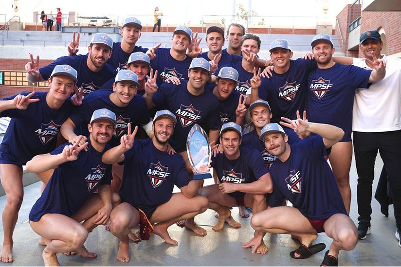 USC mens water polo team raising the victory sign