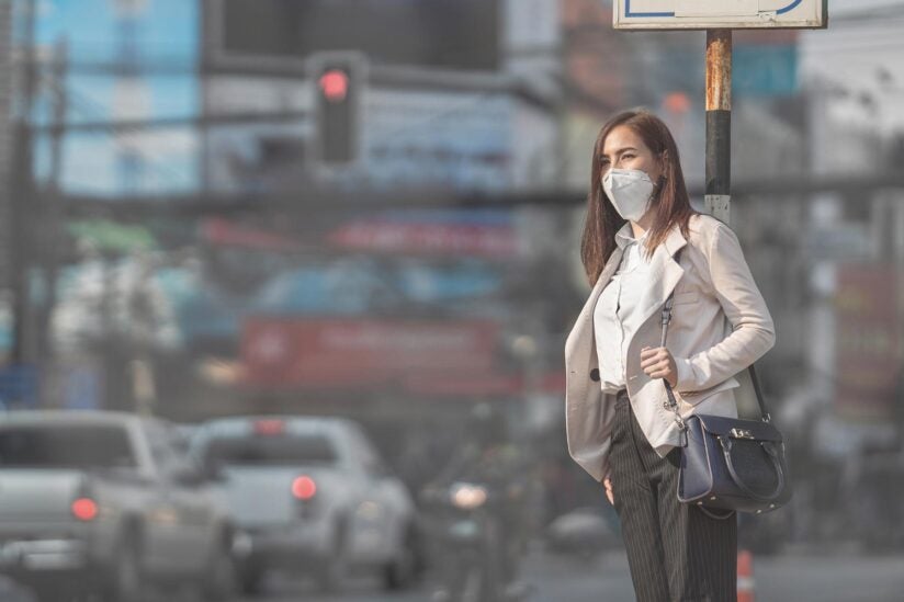 Photo of woman crossing street in an urban city