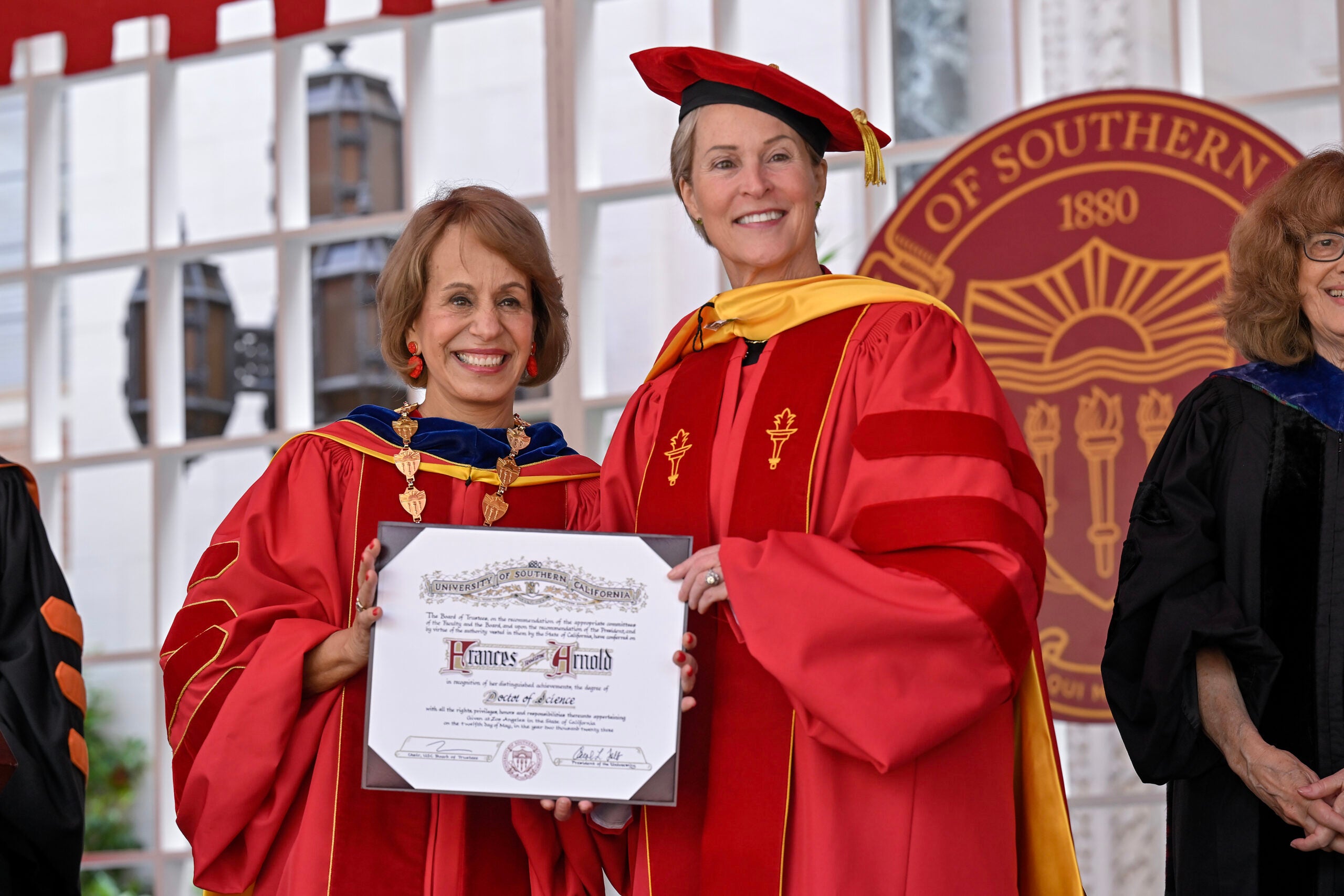 USC President Carol L. Folt presents chemist and bioengineer Frances Hamilton Arnold with a honorary doctor of science degree during the 140th commencement ceremony at the University of Southern California, May 12, 2023. (Photo/Gus Ruelas)
