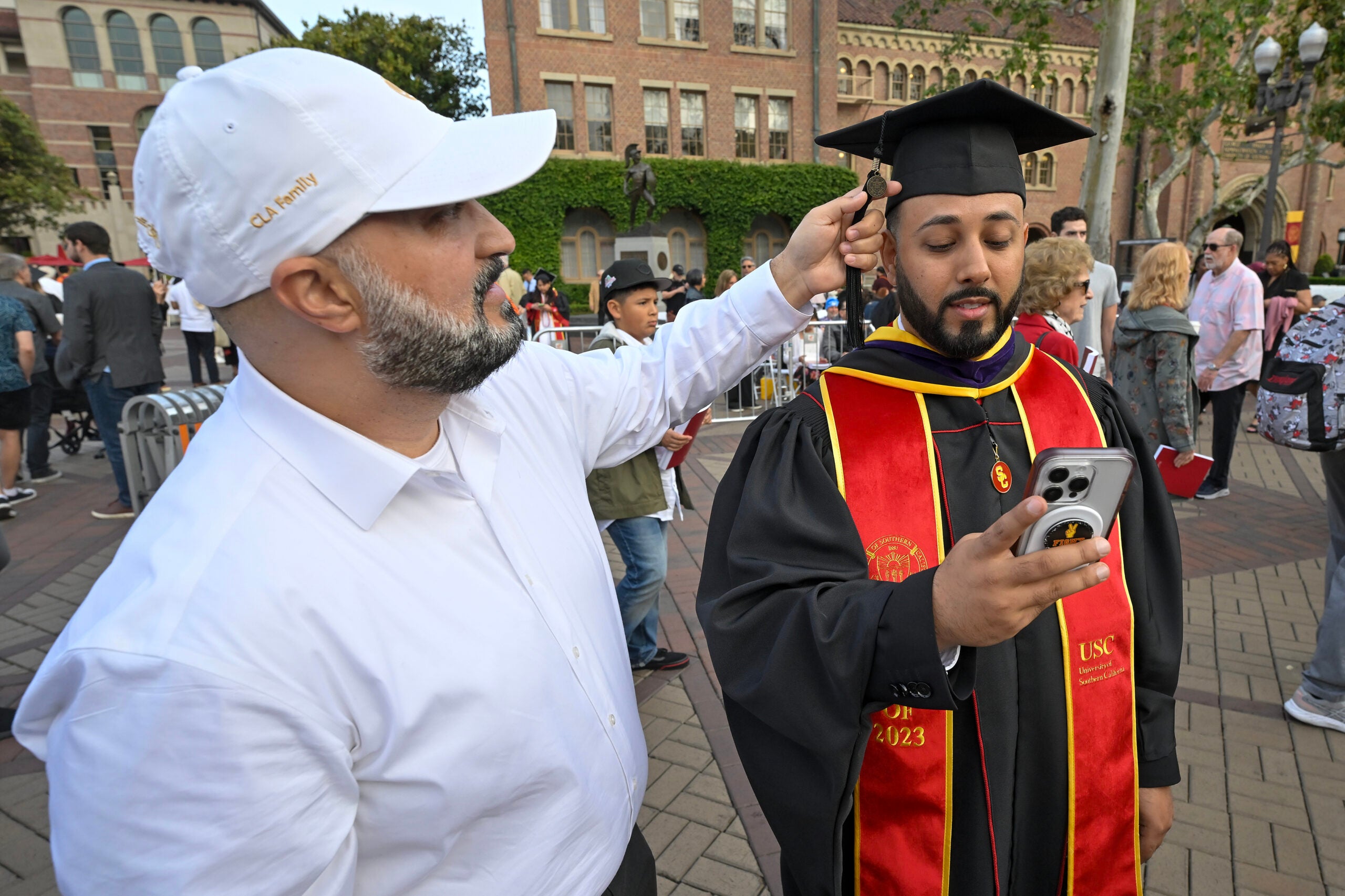 Shabear Adina adjusts brother Kabir Adina’s tassel during the 140th commencement ceremony at the University of Southern California, May 12, 2023. (Photo/Gus Ruelas)