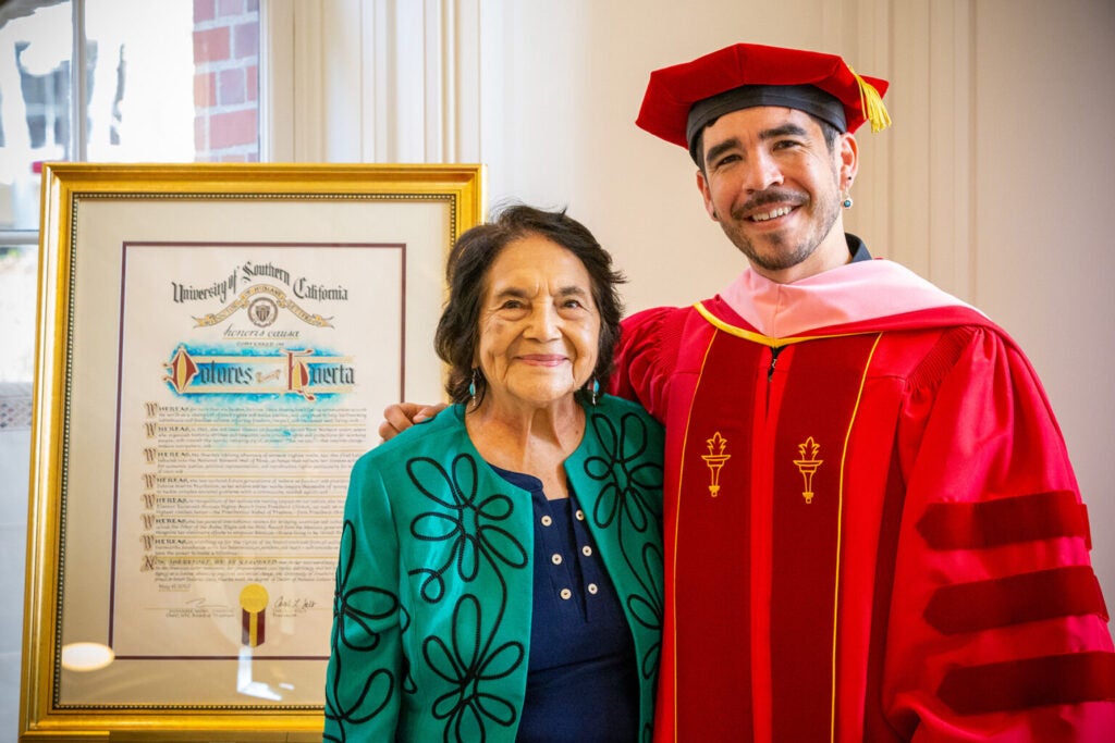 Photo of Dolores Huerta and younger cousin receiving diplomas