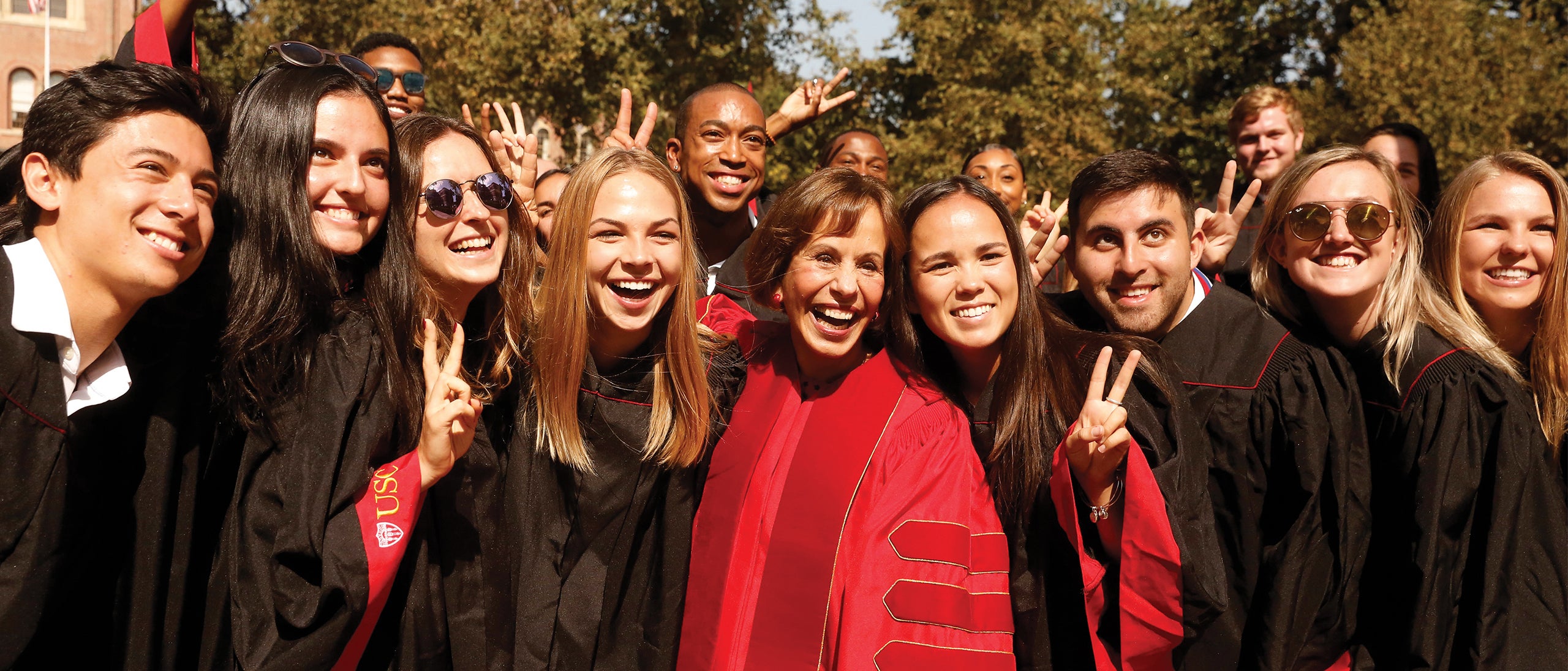 President Carol Folt with several new USC students after presiding over her first convocation ceremony at USC.